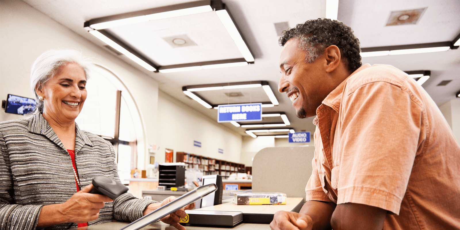 Library worker and patron at a counter